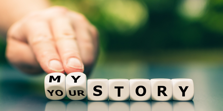 Hand turns dice and changes the expression "your story" to "my story".